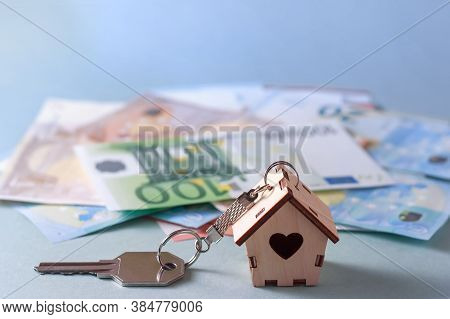 Mortgage, Investment, Real Estate And Property Concept - Close Up Of Home Model, Money And House Key