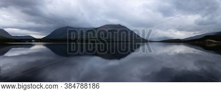 Panoramic View Of Nares Lake With Mountains In The Background During A Cloudy Evening. Taken In Carc