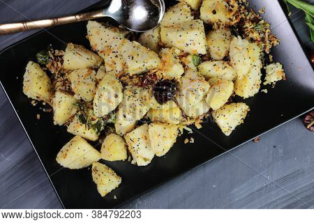 Idli Fry Made From Fermented Rice And Urad Daal Cakes Called Idis On A Dark Background.