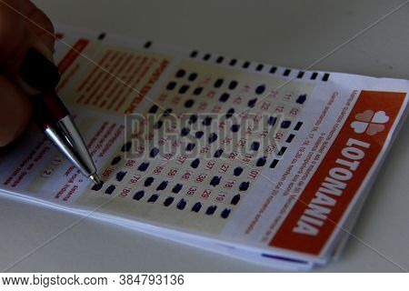 Salvador, Bahia / Brazil - December 10, 2013: Bookmaker Marking Ticket Of The Game Lotomania, Lotter