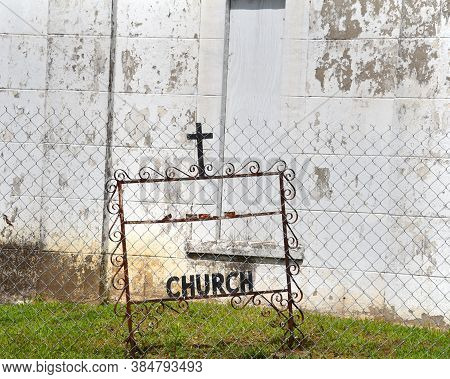 Church Closed Off With Chain Link Fence