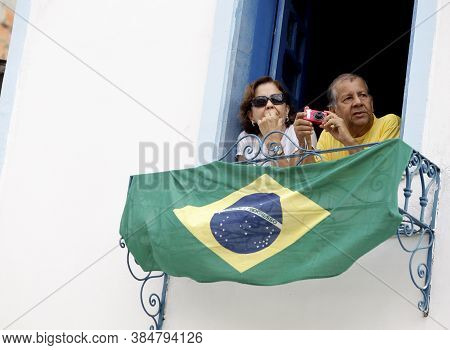 Salvador, Bahia / Brazil - July 2, 2015: Person Holds Brazilian Flag In The Lapinha Neighborhood Of 