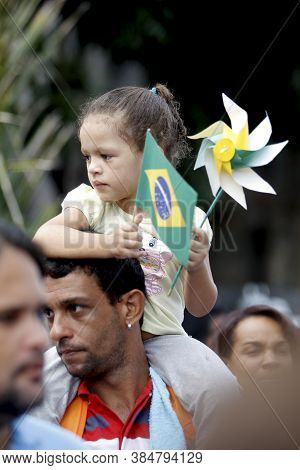 Salvador, Bahia / Brazil - July 2, 2015: Person Holds Brazilian Flag In The Lapinha Neighborhood Of 