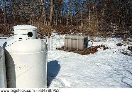 A Residential Standby Generator And Propane Tank