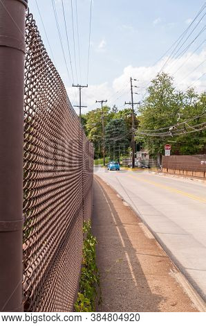 Braddock Hills, Pennsylvania, Usa 9/10/20 A Chain Link Fence Running Along The Brinton Road Bridge W