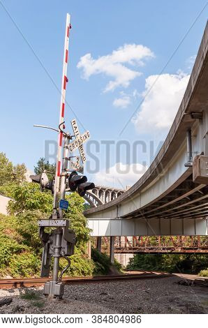 A Railroad Crossing Arm On A Set Of Tracks Next To The Braddock Avenue Overpass And Under The East P