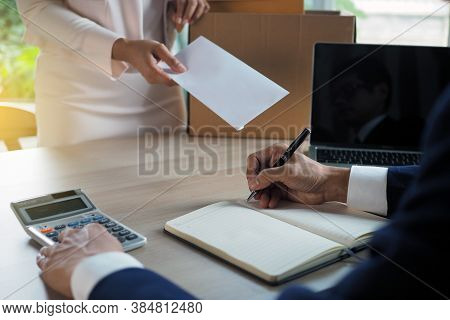 The Business Woman Has A Brown Cardboard Box Next To Her Body And Sends A Letter Of Resignation To T