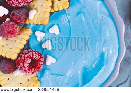 Close Up Of Healthy Fruit Smoothie Bowl Dyed With Natural Blue Spirulina Powder And Topped With Red 