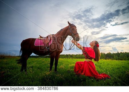A Woman In A Bright Gypsy Dress And Image With A Horse In A Field With Green Grass. A Model Or Actre