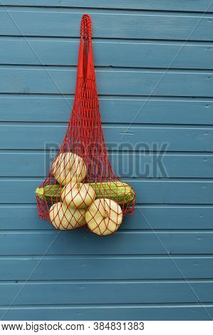 Fresh Crop Of Pattison Vegetables On A Blue Background. Eco-friendly Mesh Bag On A Blue Background. 