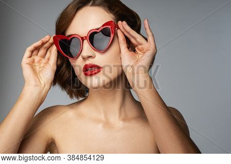 Carefree Woman With Red Lipstick In Heart-shaped Sunglesses