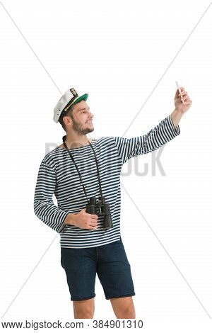 Taking Selfie. Caucasian Male Sailor In Uniform On White Studio Background. Young Man Using Modern D
