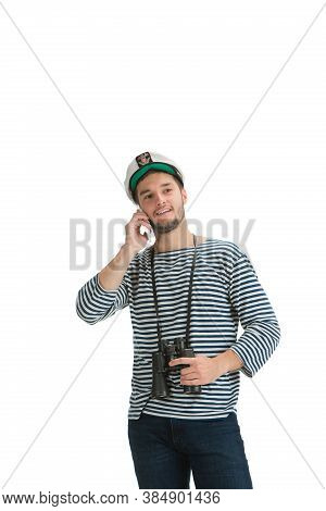 Talking Phone. Caucasian Male Sailor In Uniform On White Studio Background. Young Man Using Modern D