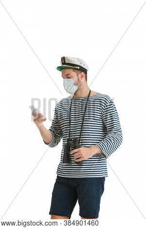 Scrolling Phone. Caucasian Male Sailor In Uniform On White Studio Background. Young Man Using Modern