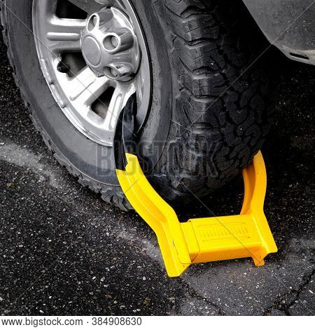 Wheet boot or tire lock on a vehicle or car for illegal parking violation 