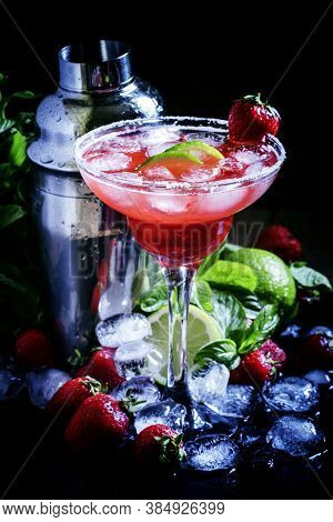 Alcoholic Cocktail With Strawberry, Lime And Ice In The Glass, Decorated With Sugar, Black Backgroun