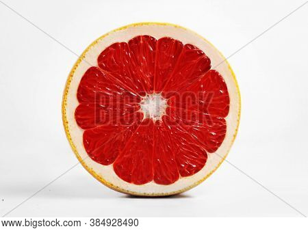 Fresh Red Grapefruit. Slice. White Background. Side View