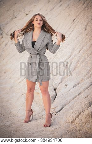 Full body sensual portrait of young pretty lady holding her hair