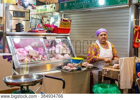 Singapore - 11 2018: Butcher At Work At Tekka Indian Market