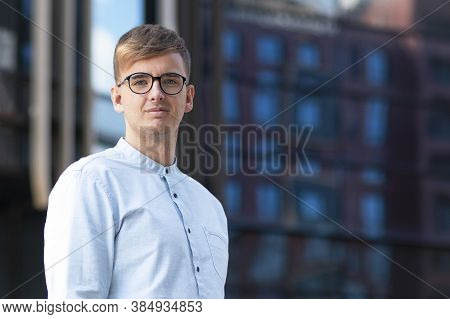Portrait Of A Handsome Male Businessman With Glasses Looking Directly At The Camera. Young Student G