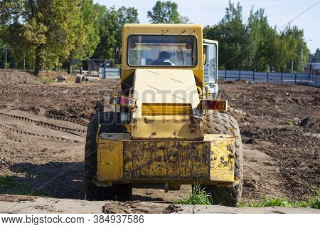 Bulldozer At A Construction Site. Heavy Construction Equipment. Sand Compactor. Multi-ton Diesel Car