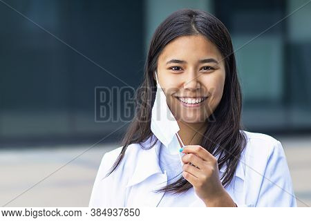 Asian Woman, Attractive Ethnic Girl Takes Off The Medical Mask From Her Face, Happy With A Smile Loo