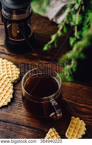 Cup Of Coffee Brewed In French Press With Cookies On Rustic Wooden Table
