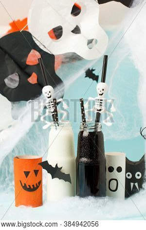 Cute Halloween Balck Whitel Drinks For A Kids Party In Spider Cobweb On Blue Background, Funny Food 