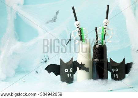 Cute Halloween Balck Whitel Drinks For A Kids Party In Spider Cobweb On Blue Background, Funny Food 