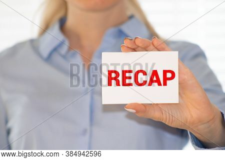 Recap Word On White Card Paper Sheet On In Hands Of A Businessman Blurred. Recap Concept