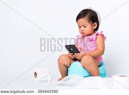 Asian Little Cute Baby Child Girl Education Training To Sitting On Blue Chamber Pot Or Potty And Pla