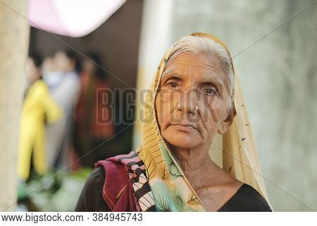 Ahemdabad, Gujarat, India - 20th June, 2019: Old Indian Village Woman Wearing Saree Looks At The Cam
