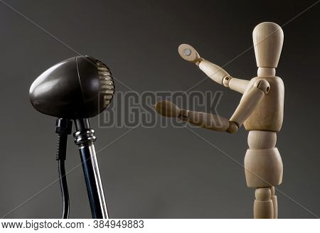 Wooden Dummy Singer Singing Into Antique Microphone .