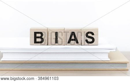 Bias - Word From Wooden Blocks With Letters, Personal Opinions Prejudice Bias Concept, Cubes On Book