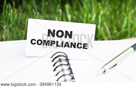 Text Non Compliance On The Card Lying On The Notebook