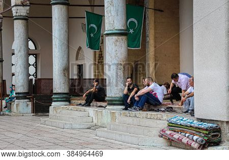Sarajevo, Bosnia And Herzegovina - July 3rd 2018: Muslims Sitting Outside Gazi Husrev-beg's Madrasa 