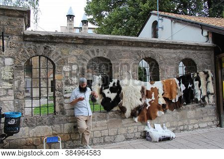 Sarajevo, Bosnia And Herzegovina - July 3rd 2018: A Muslim Street Seller, Selling Animal Skins Outsi