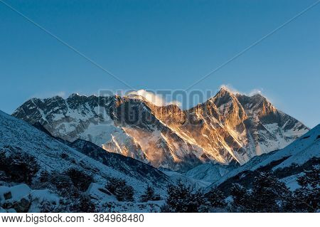 Sunrise On Nuptse, Lhotse And Mount Mt. Everest Peaks With Bird Of Prey At Front. Trekking In Nepal 