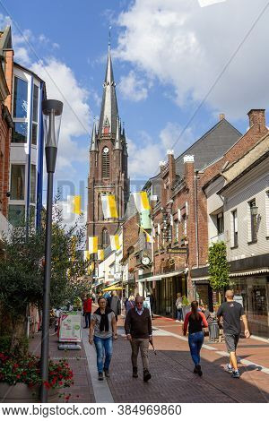 Kevelaer, Germany - Sept 5, 2020: Shopping Street With People And White And Yellow Flags With A View