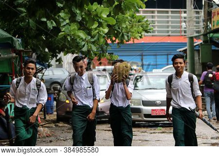 Yangon, Myanmar June 11, 2018: Four Collegians In Myanmarese Uniform Of College (white Shirt And Gre
