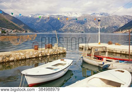 Winter Mediterranean Landscape With Fishing Boats In Small Harbor. Montenegro, View Of Kotor Bay Nea