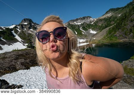 Blonde Woman Makes A Duck Face Kisses Pose At Heather Meadows In The Mt Baker Area Of Washington Sta