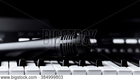 Microphone On Keyboar. Close Up. Dark Background.