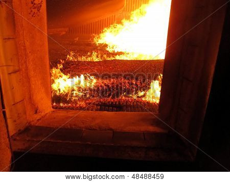 Fire The Combustion Of Biomass In The Form Of Pellets In The Boiler Stoker Coal, Visible Through The