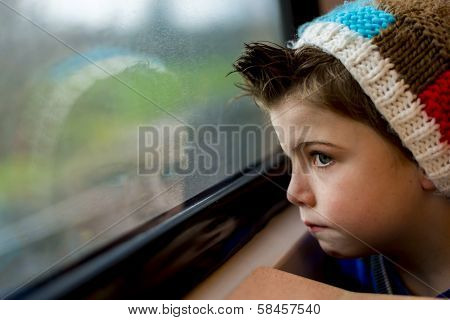 Boy Staring Through Window