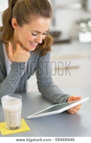 Happy Young Woman With Smoothie Using Tablet Pc