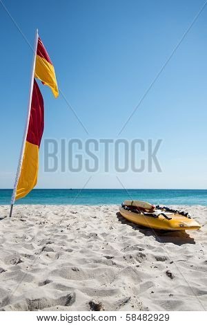 White sand beach and lifesaver surfboard