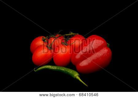 Frech Tomatoes, Green Chilli And Red Capsicum On Black Background