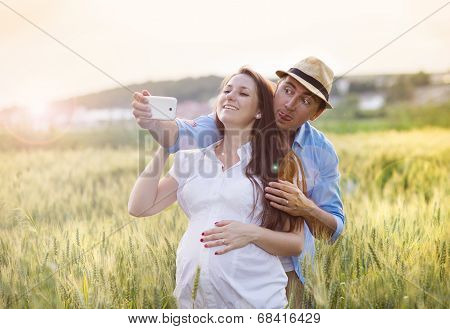 Pregnant couple taking selfie