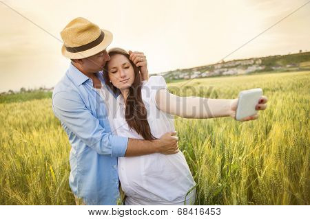 Pregnant couple taking selfie